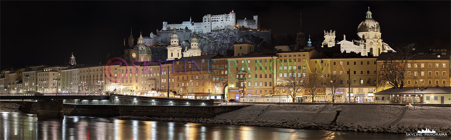 Panorama Salzburg - Die winterliche Silhouette der Salzburger Altstadt mit der Festung Hohensalzburg und dem Dom zu Salzburg vom Salzachufer aus gesehen.