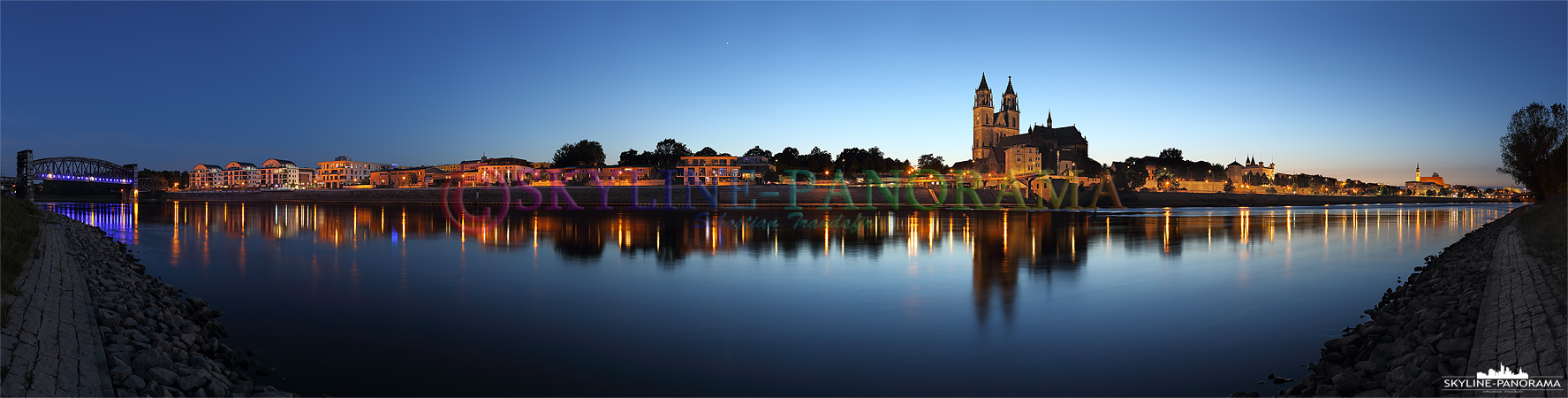 Bilder aus Magdeburg - Der Blick vom Elbufer auf die Stadtansicht von Magdeburg mit dem Dom zur Blauen Stunde. 